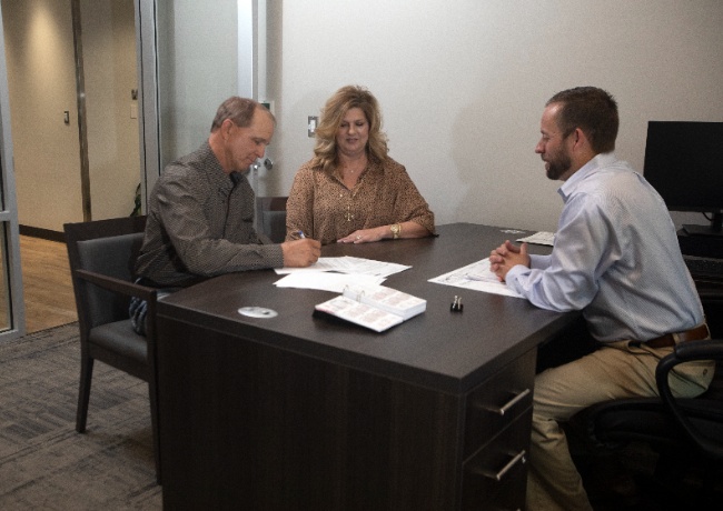 a couple with their bank representative