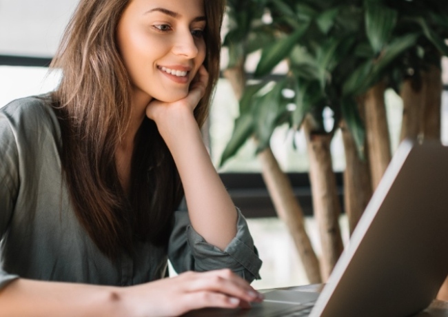 a woman viewing her laptop computer