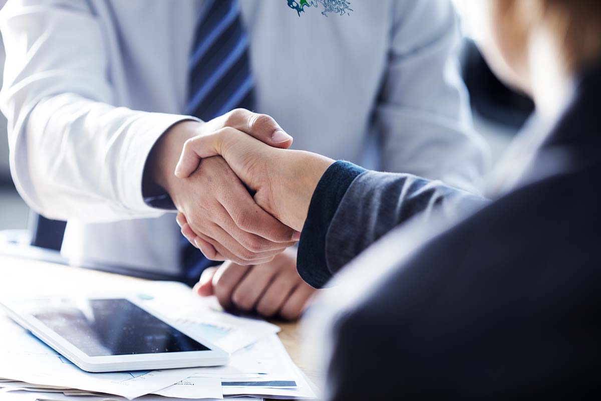 Two people engaged in a handshake.