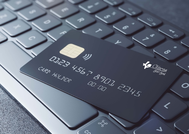 credit/debit card laying on a computer keyboard
