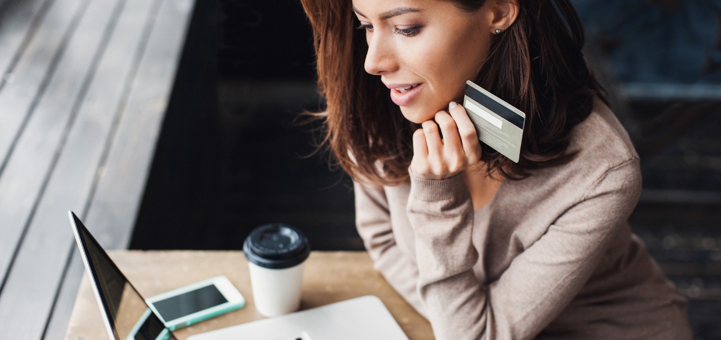 a woman making an online purchase with a debit/credit card