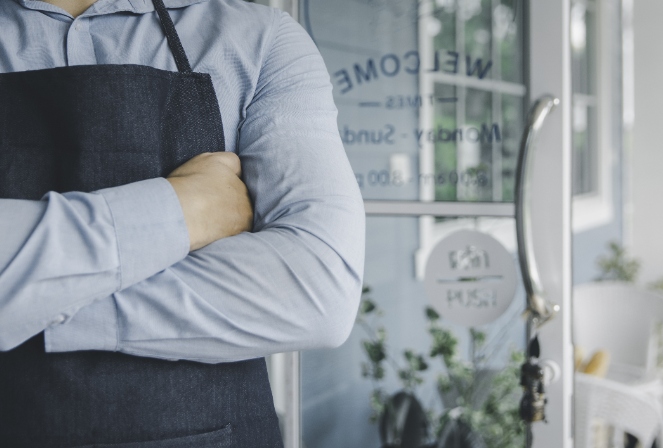 a business owner standing in front of his business.