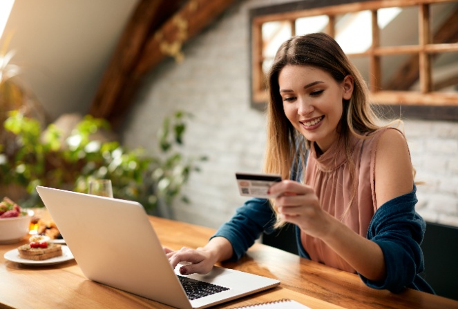 a woman making an online purchase using her debit/credit card