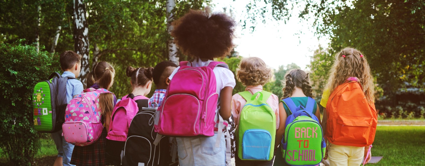 a group of children wearing back packs